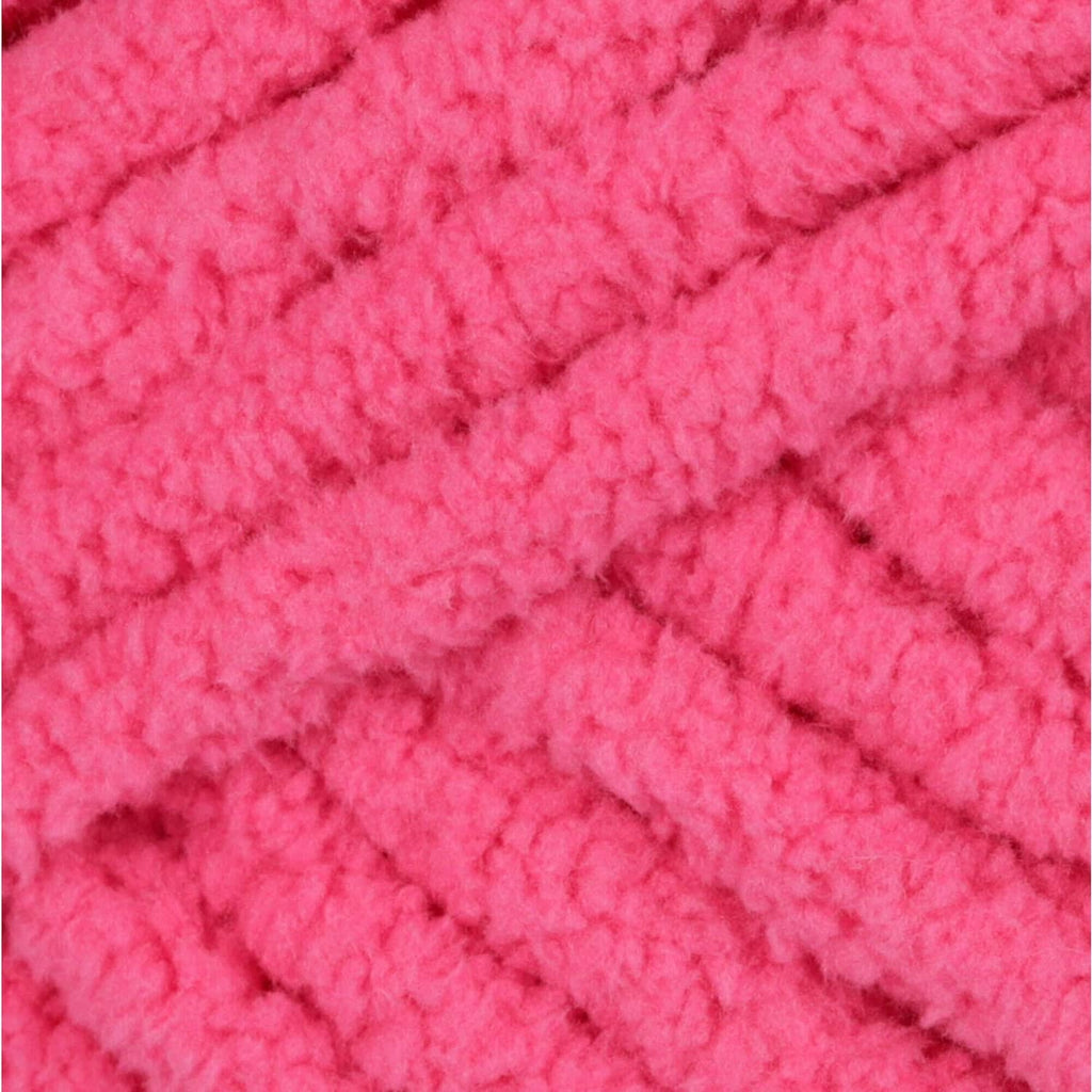 Close-up of bright pink chunky yarn knit with raised stitch pattern