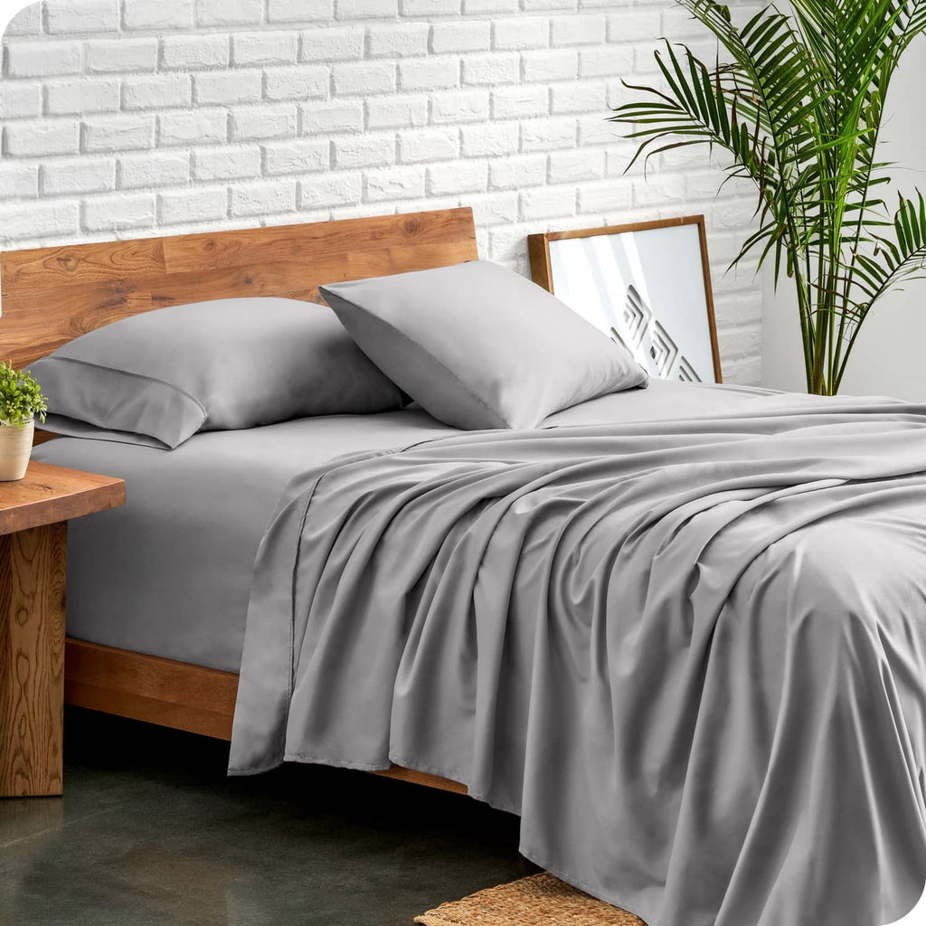 Light grey split head king sheet set on bed with two matching pillowcases
