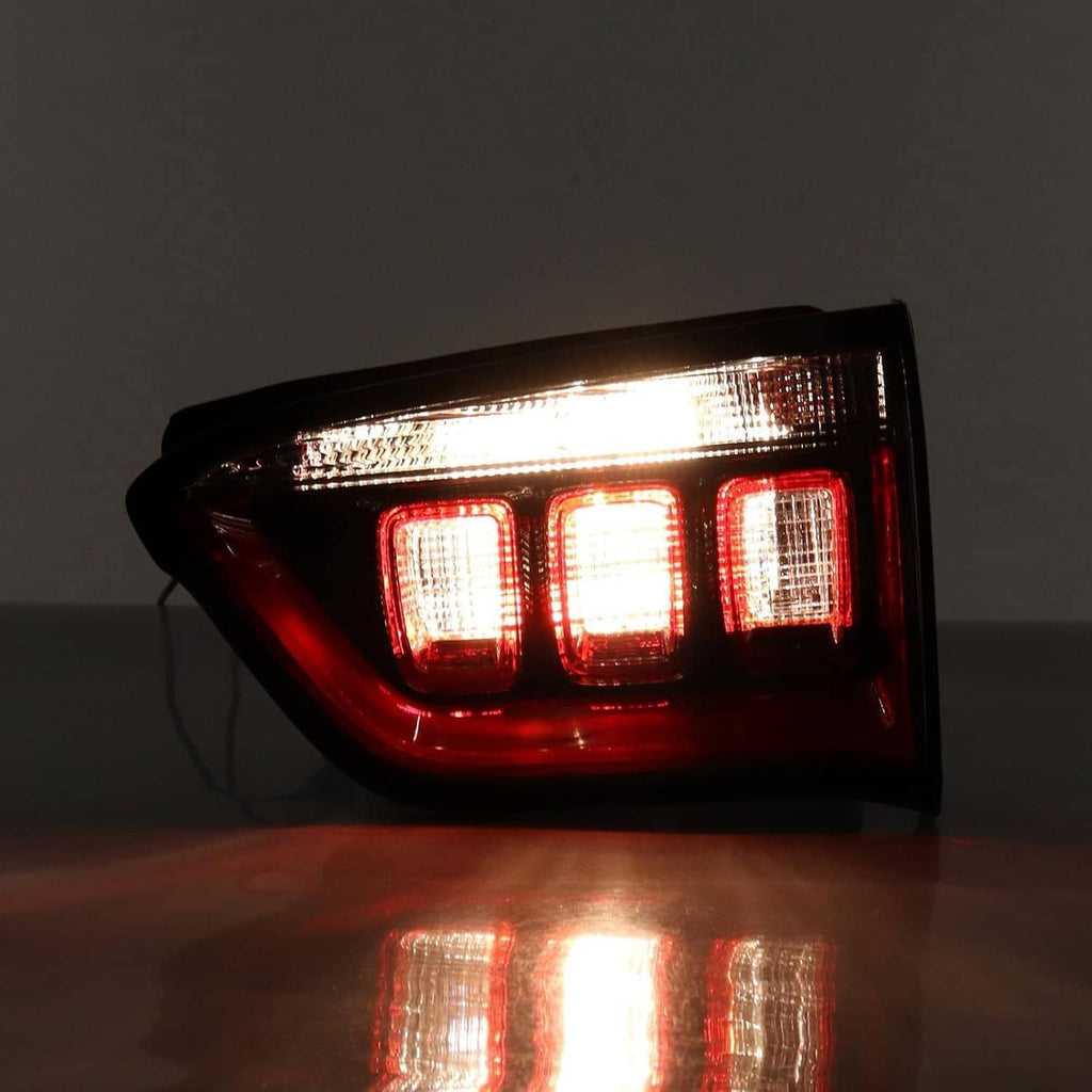 Right inner halogen tail light, three glowing red and clear segments, black surround