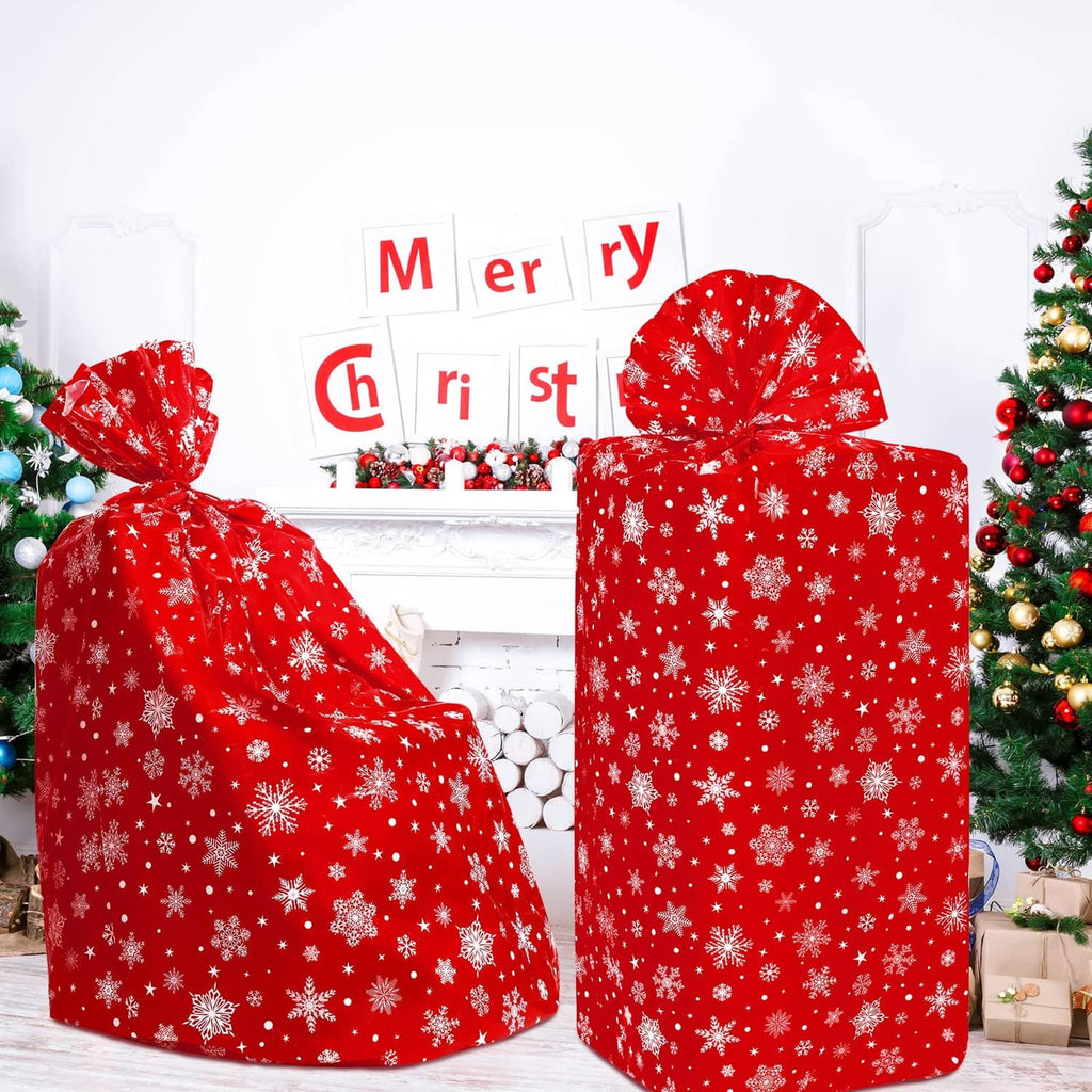Two red Christmas tree storage bags with white snowflakes, each with a tied top.