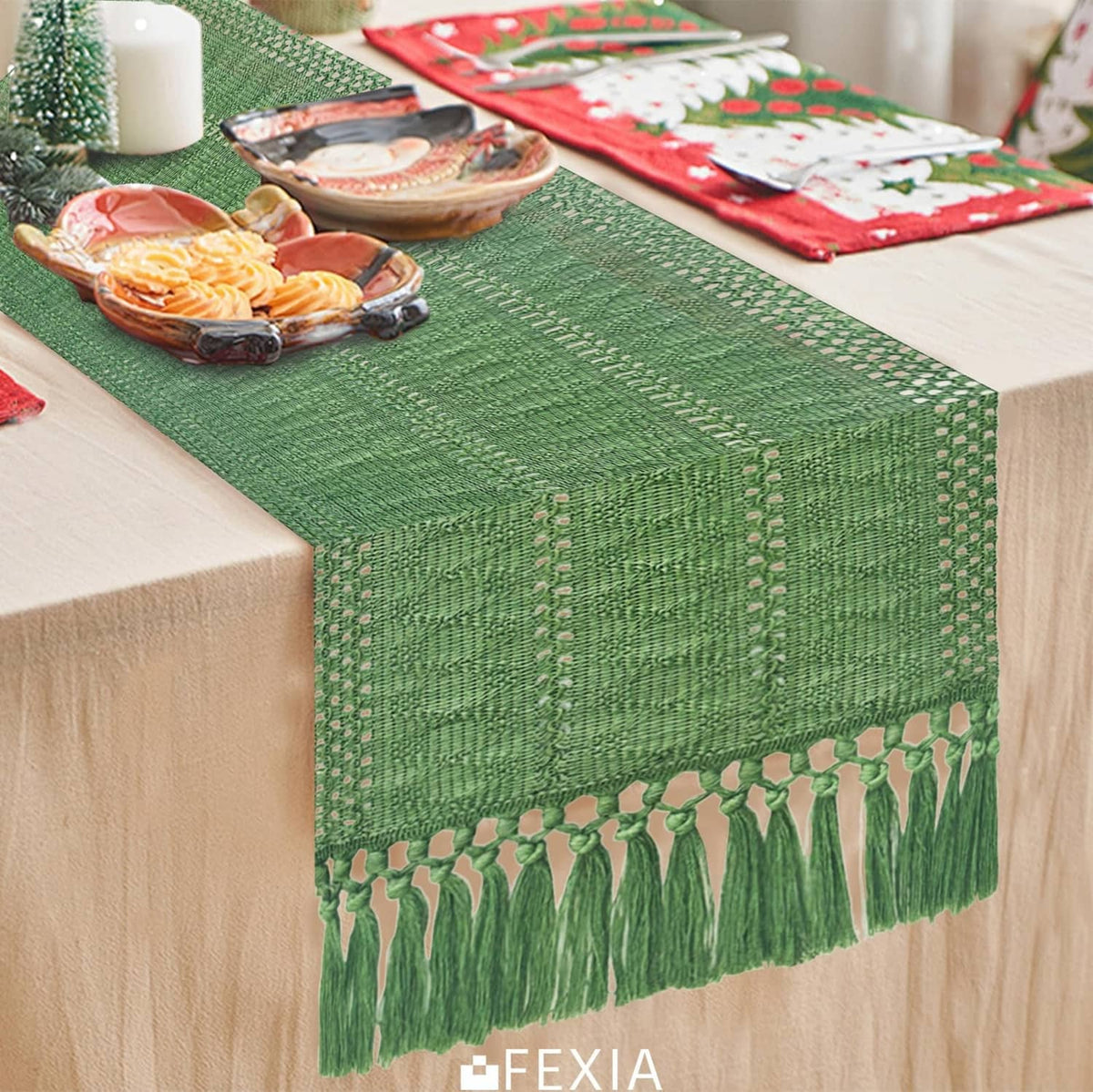 Green table runner with tassel fringe along the edge and a textured weave center.