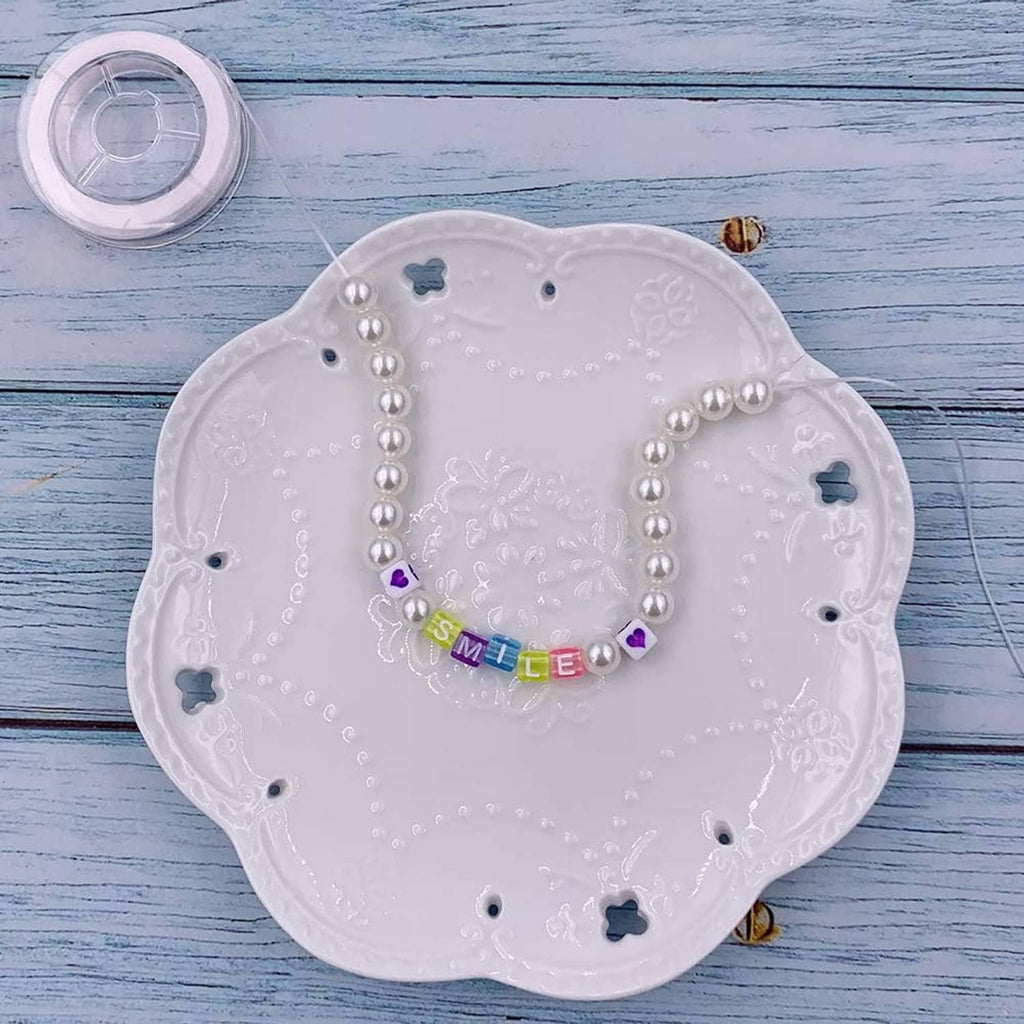 Acrylic cube letter bead bracelet with pearl beads spelling "SMILE" on elastic