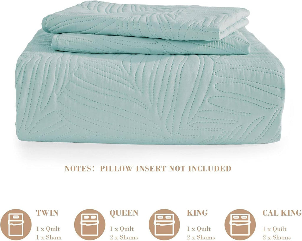 Folded aqua blue quilt with raised leaf pattern and stitched channels, lightweight bedding