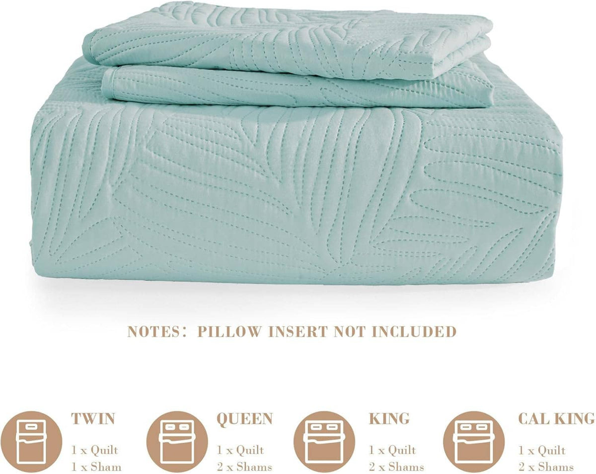 Folded aqua blue quilt with raised leaf pattern and stitched channels, lightweight bedding
