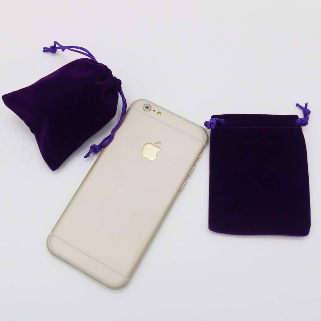 Purple velvet drawstring jewelry pouch next to a smartphone