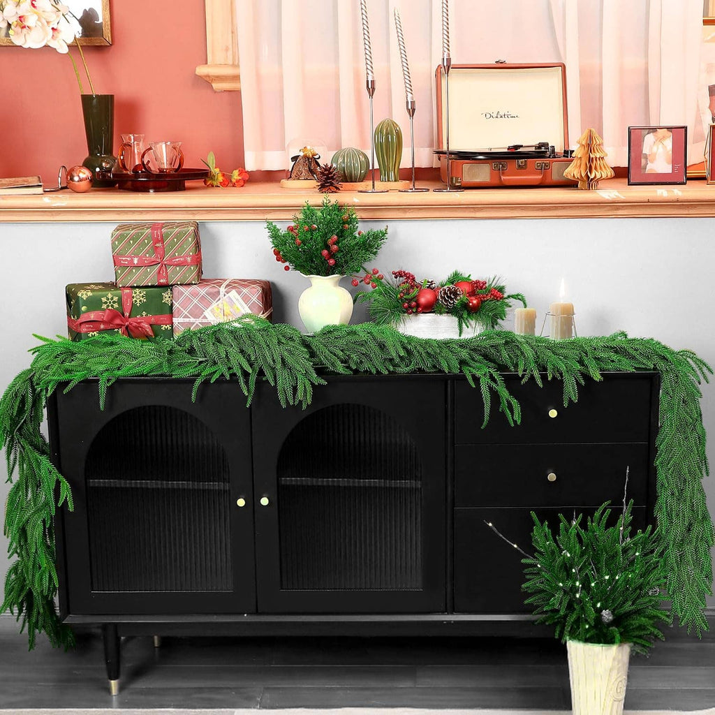 Green artificial pine garland draped along the top edge, with dense fringed needles.