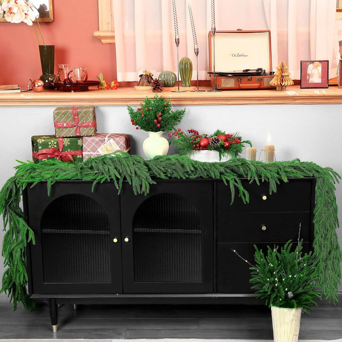 Green artificial pine garland draped along the top edge, with dense fringed needles.