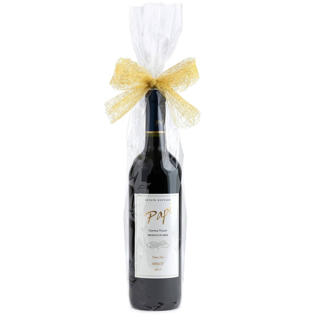 Clear cellophane wine bottle bag tied with a gold bow on a dark glass bottle