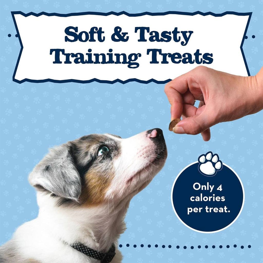 hand offering a small soft training treat to a puppy