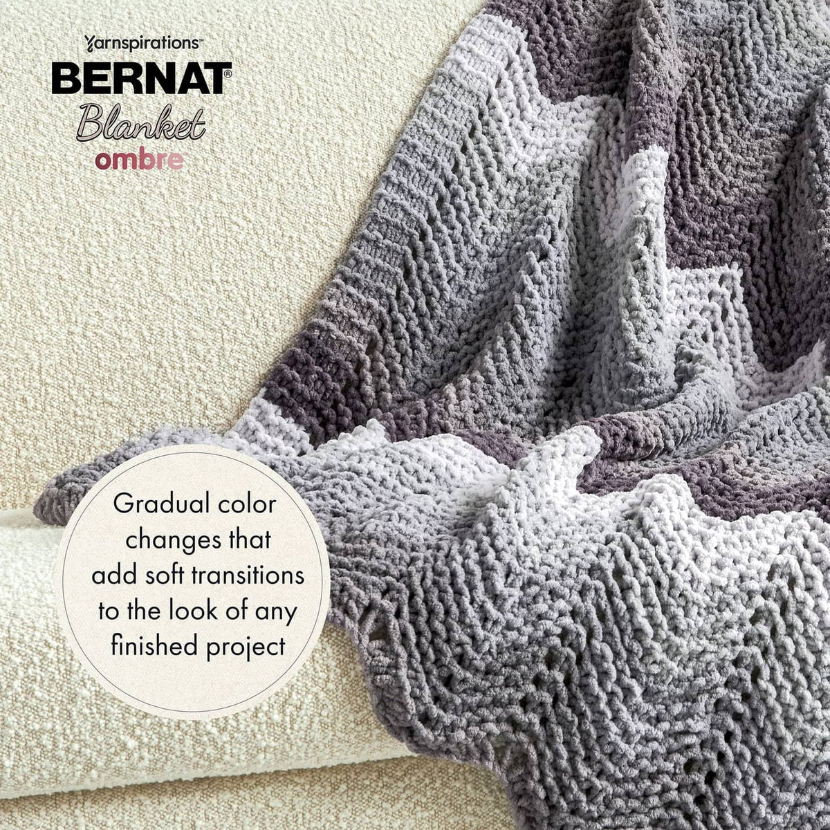 Gray and white ombre crochet blanket with chunky raised stitch texture and draped edge