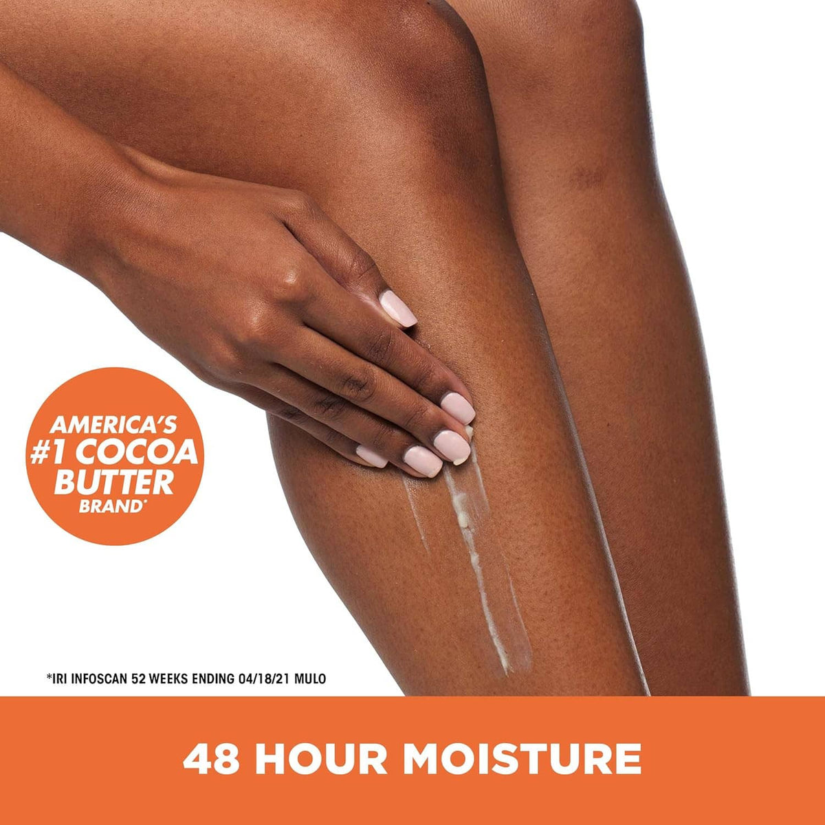 Hands applying solid cocoa butter lotion along a leg