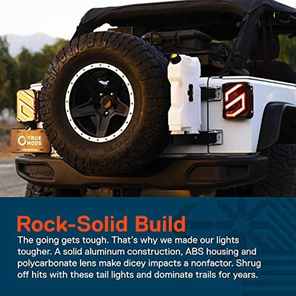 Smoked LED tail light on Jeep body, showing red bars and clear reverse area