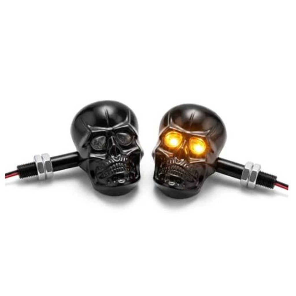 Black metal skull LED amber turn signal pair with chrome screw mounts and glowing eyes