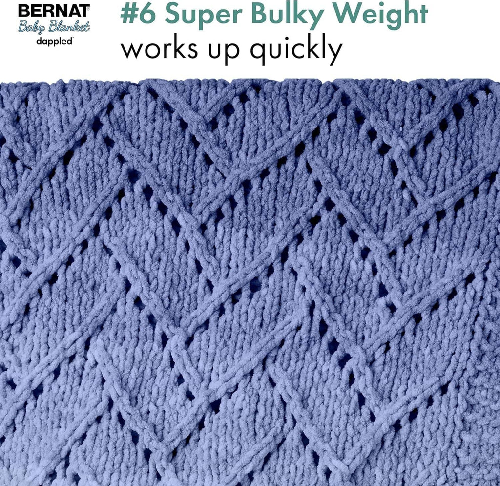 Blue dappled super bulky knit baby blanket with open chevron pattern