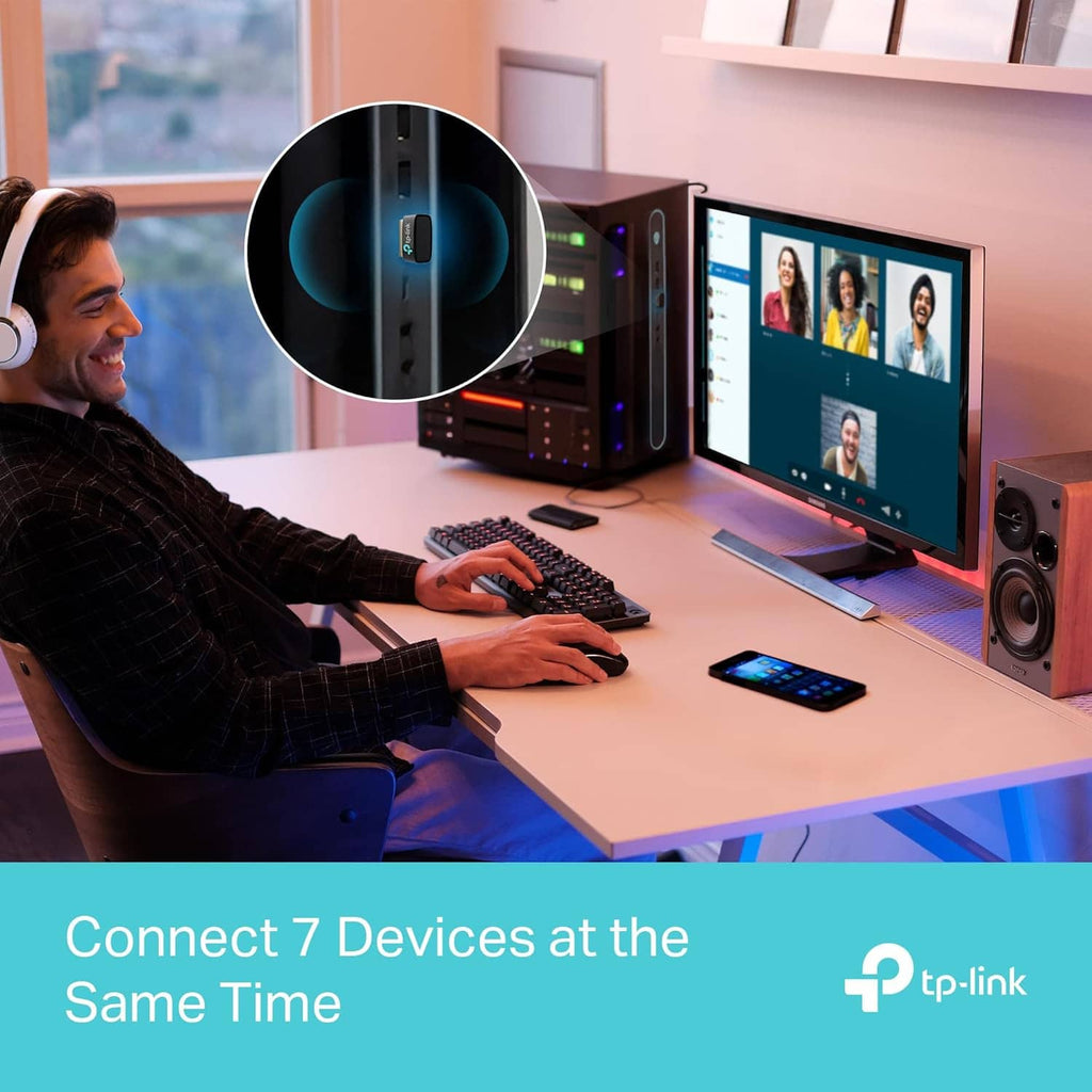 USB Bluetooth adapter in office desk setup with computers and connected device icon overlay