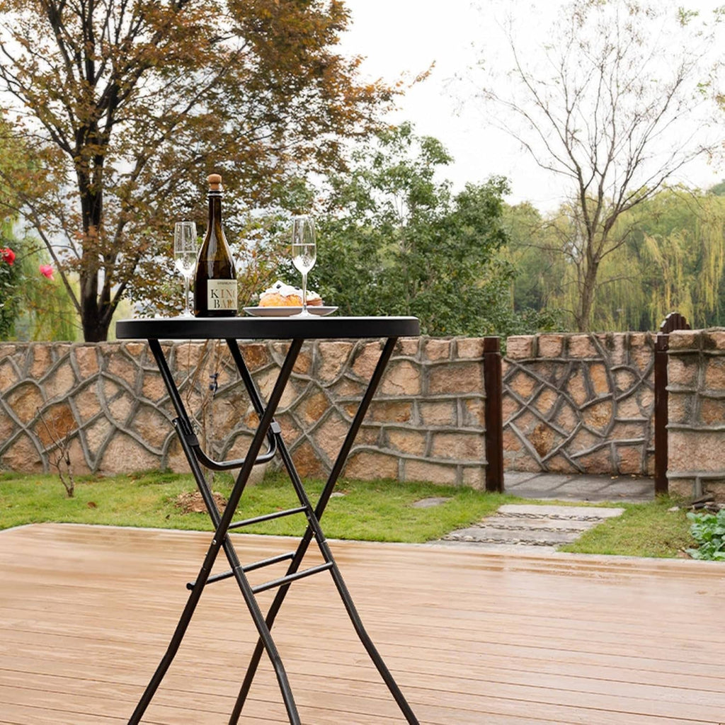 Round black folding cocktail table with plastic top and crossed metal legs, high height