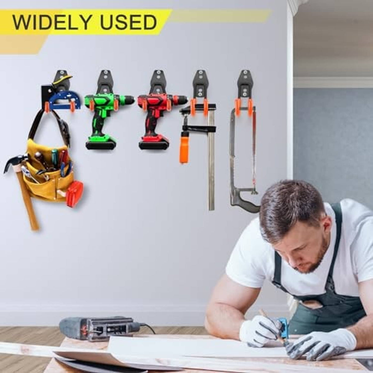 Several black U hooks on wall holding tools; sturdy heavy-duty storage organizer