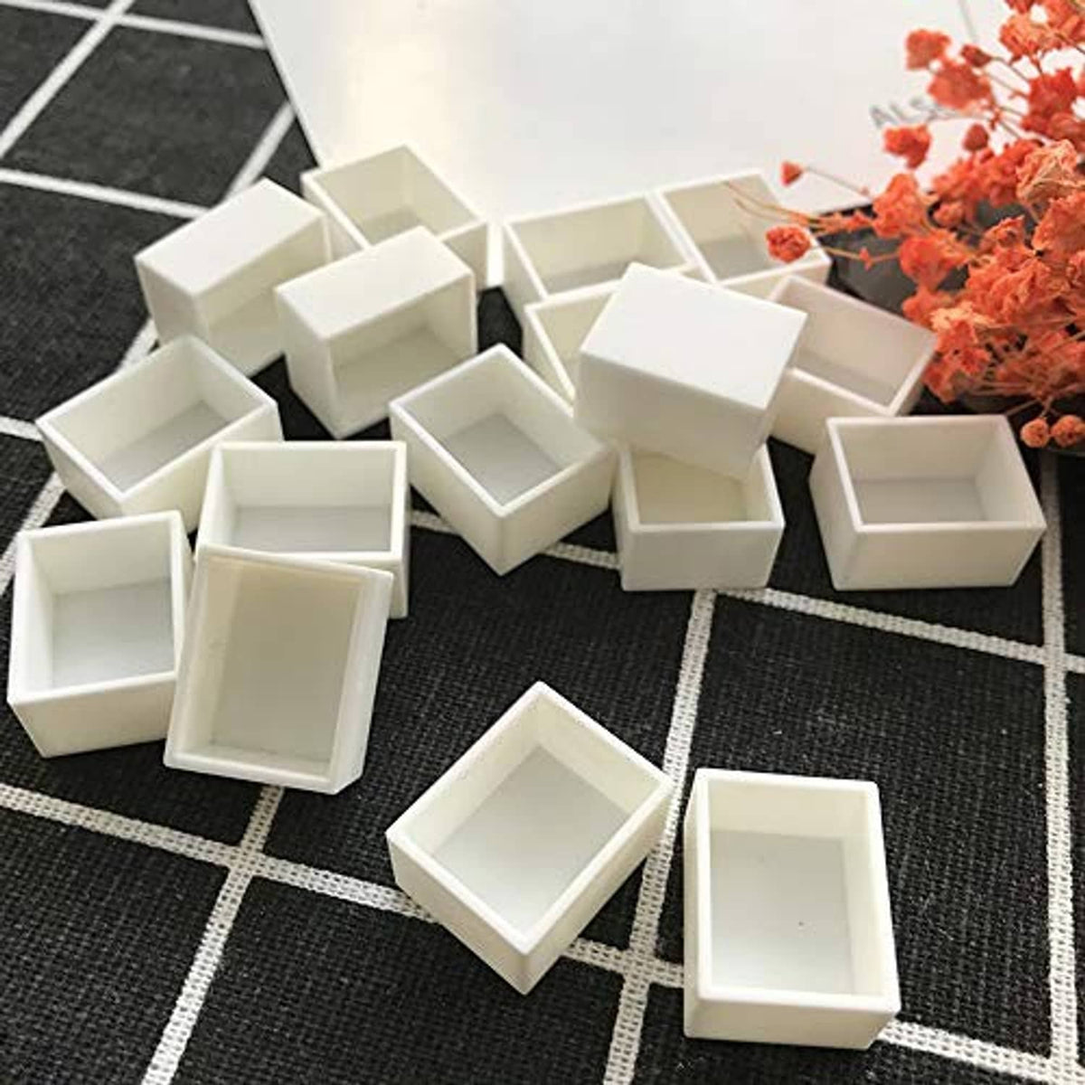 White watercolor half pans set with individual square cups on grid surface