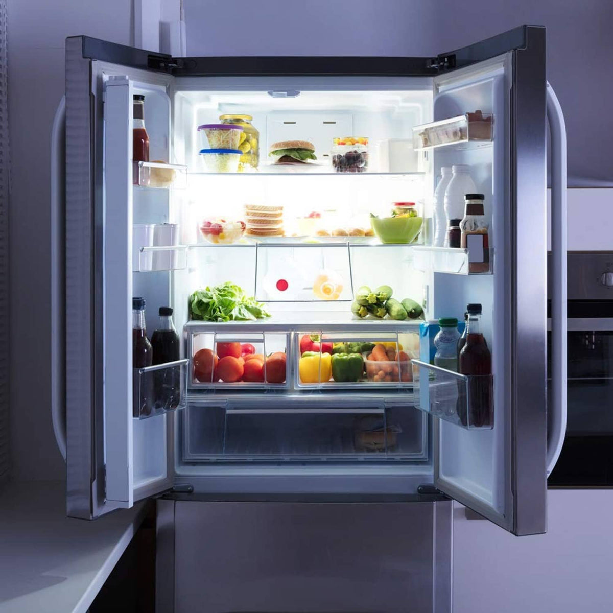 LED refrigerator light bulb glowing inside open refrigerator, bright interior shelves