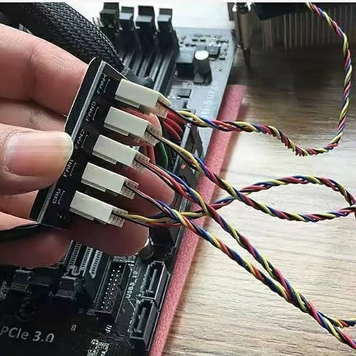 Close-up of multicolored 4-pin fan headers on PWM fan hub splitter