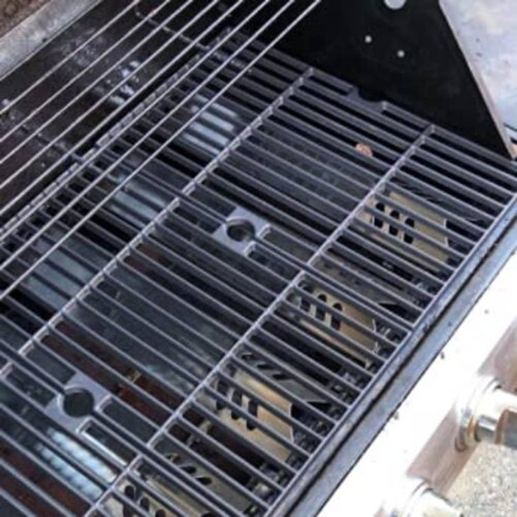 Stainless steel grill heat plate grids installed inside the grill with bars visible