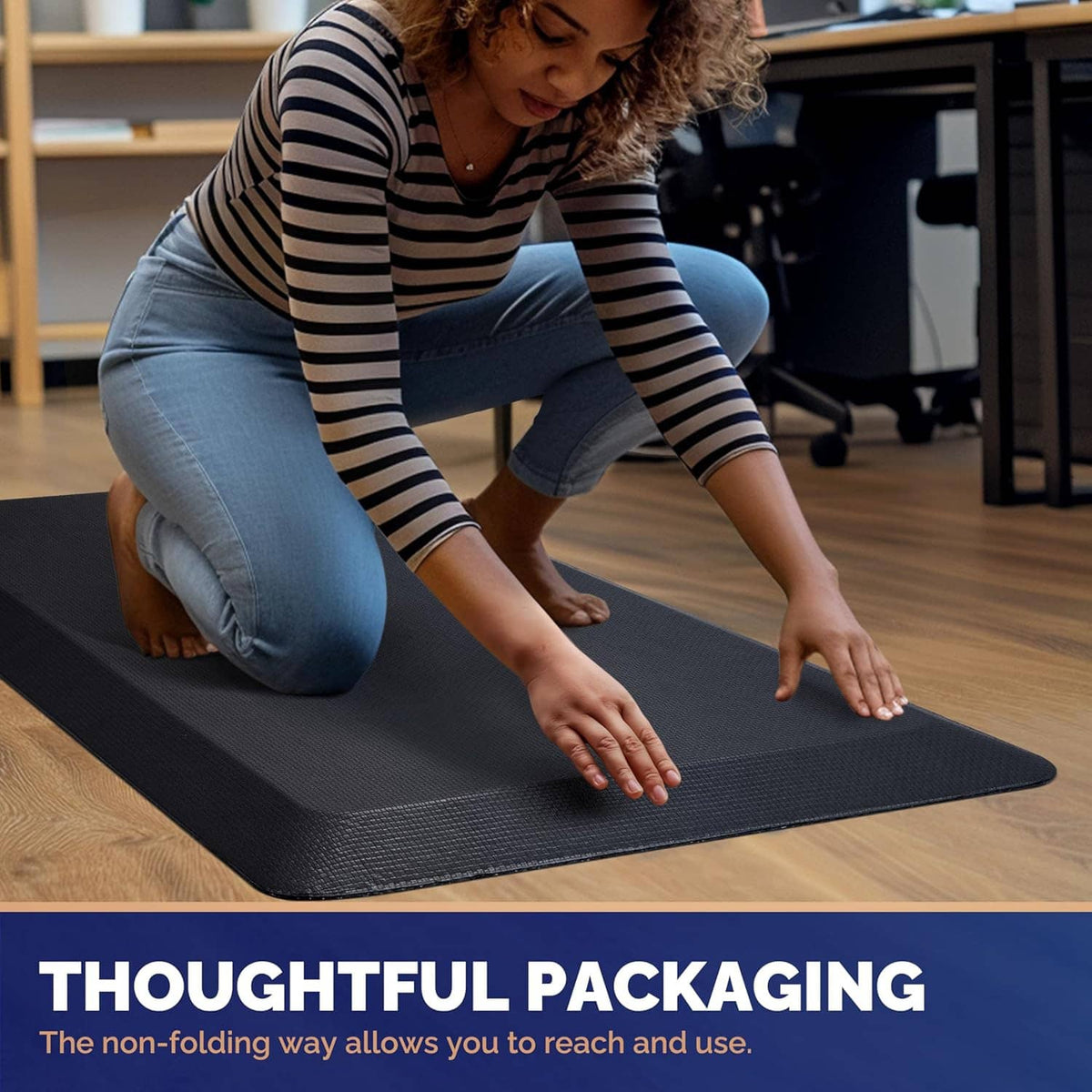 Dark textured anti-fatigue mat being unrolled by person on floor