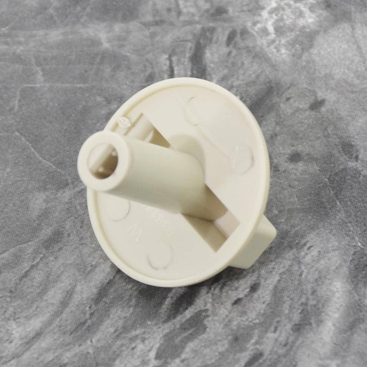Off-white temp control knob underside with mounting post