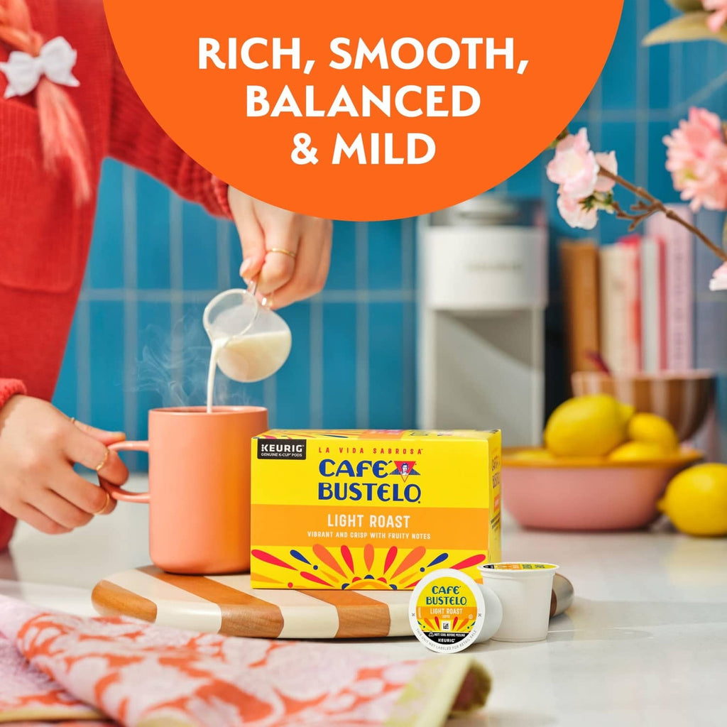 Milk being poured into a cup with Cafe Bustelo Light Roast pods and box