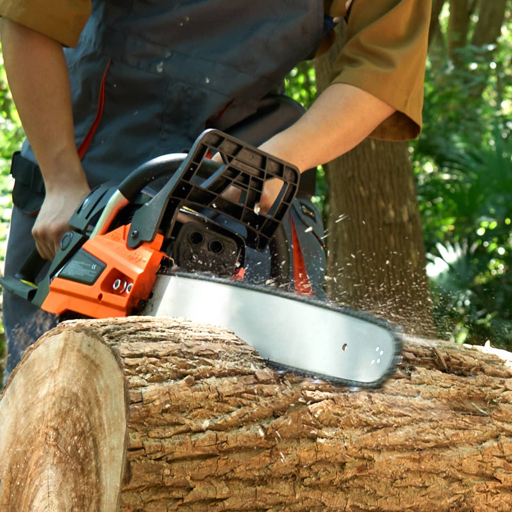 Close-up of orange and black chainsaw cutting a log with steel guide bar