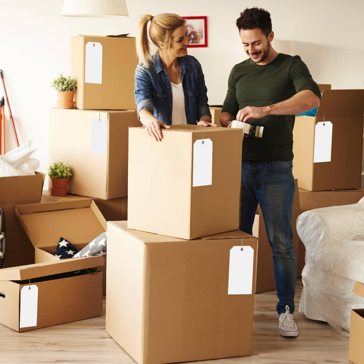 White plastic shipping tags attached to cardboard boxes for labeling
