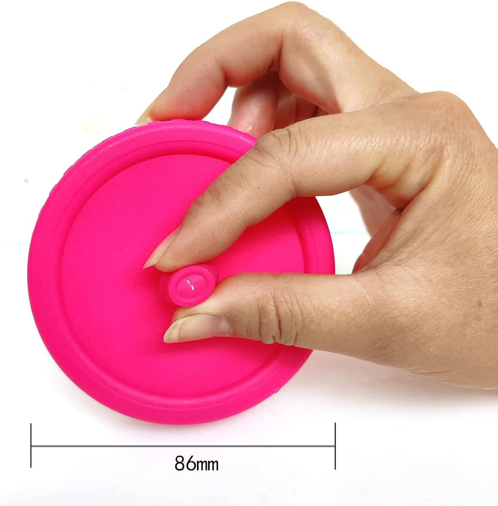 Pink airlock fermentation lid with valve, held by hand