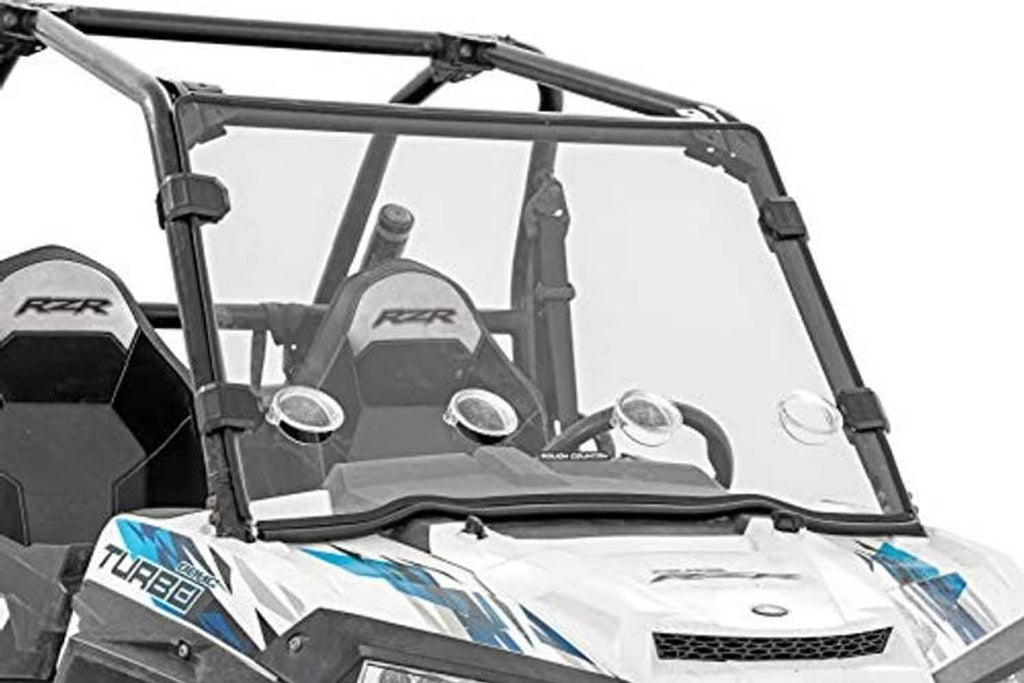 Front tinted windshield panel with black side brackets on UTV roll cage frame