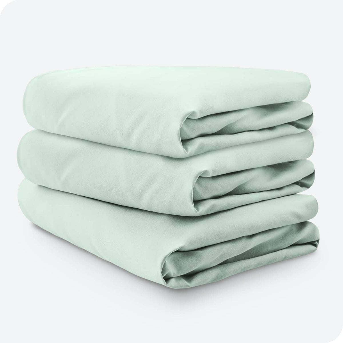 Three-pack mint green microfiber crib fitted sheets, neatly stacked