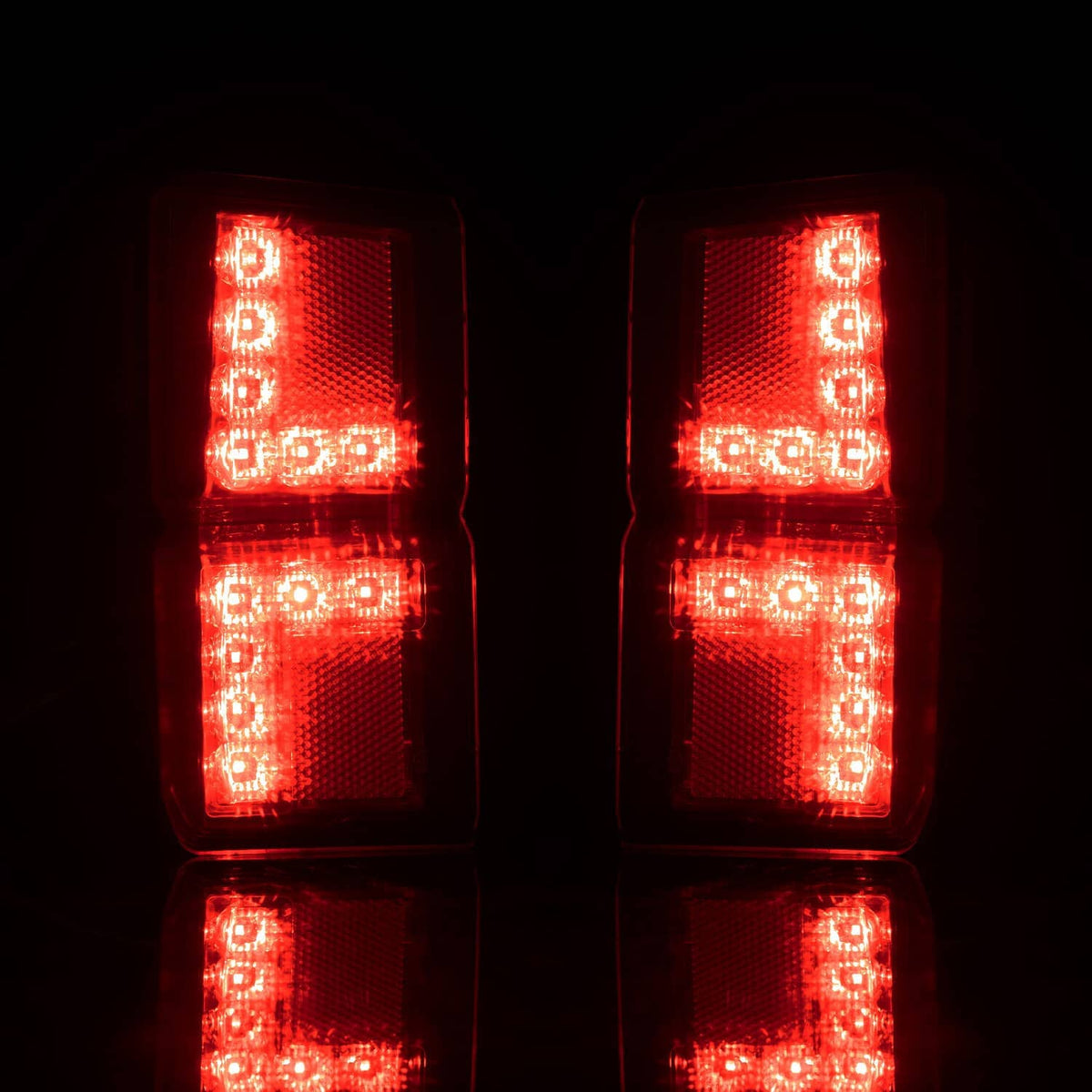 Bright red LED rear tail lights with stacked vertical lens blocks, illuminated