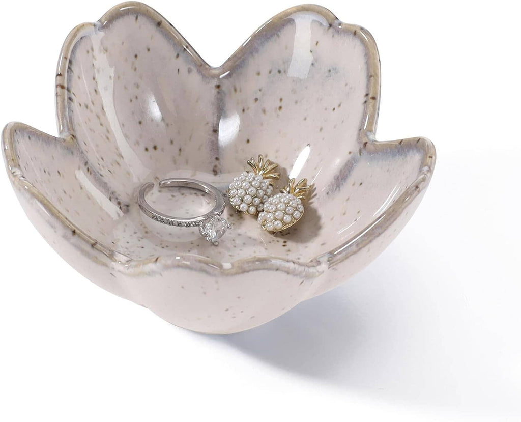 Speckled ceramic flower-shaped ring holder tray with two rings and floral charm