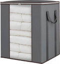 Gray fabric blanket storage bag with brown trim, open front showing folded white bedding