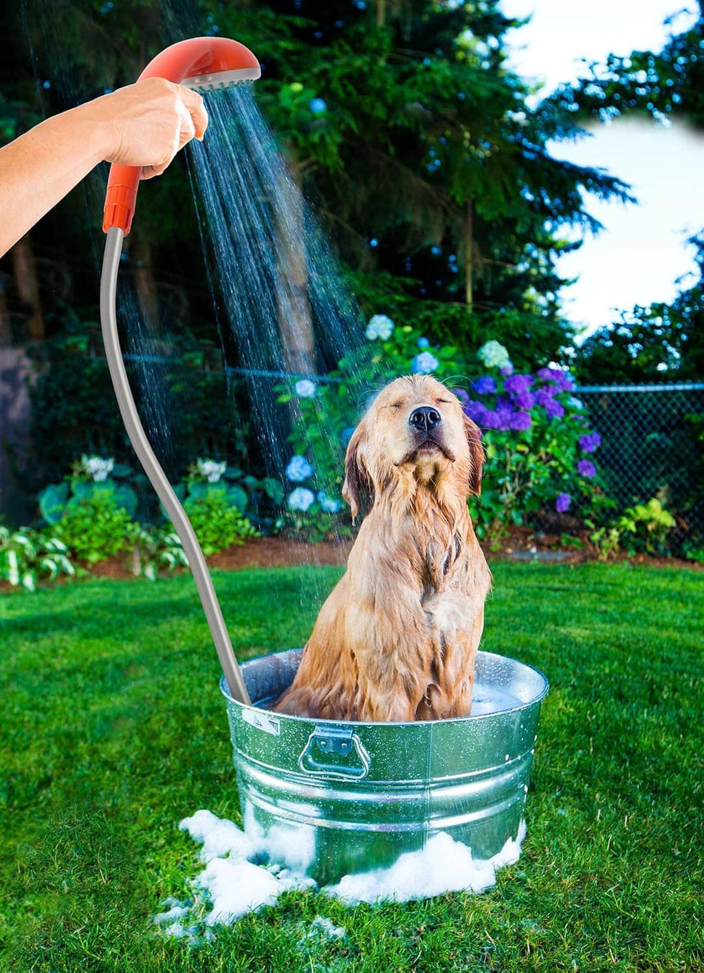 Portable handheld shower pouring water from orange sprayer