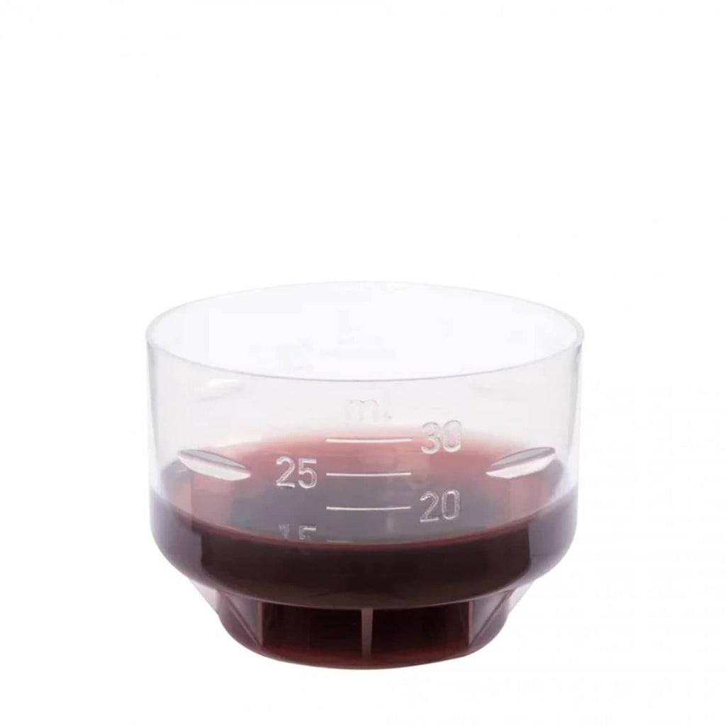 Cup with dark brown liquid sample, marked measurement lines