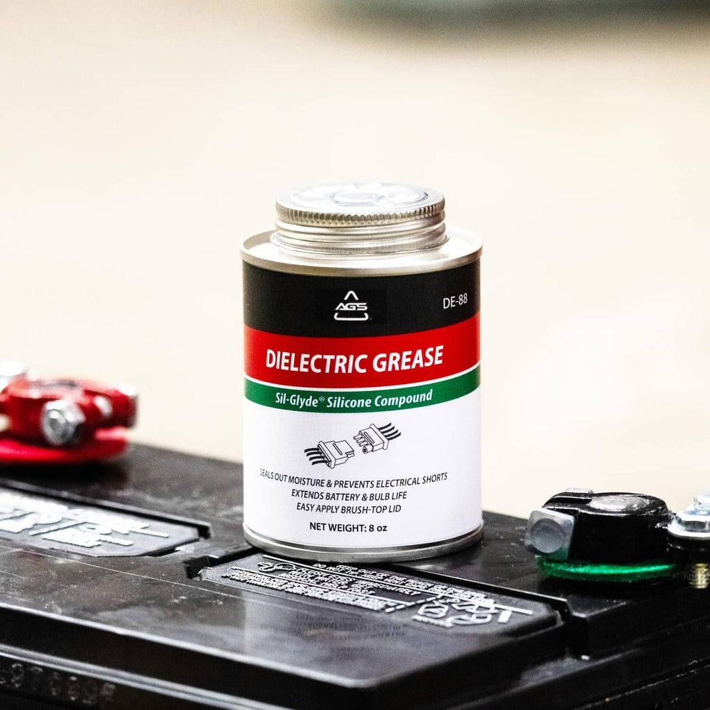 Dielectric silicone grease can on automotive fuse block with terminals