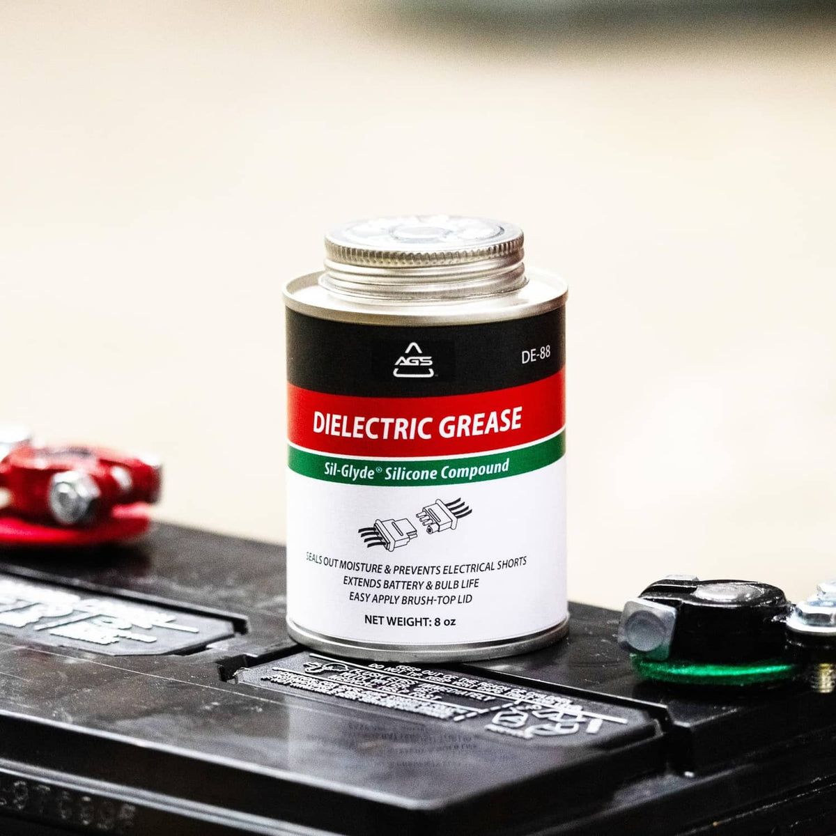 Dielectric silicone grease can on automotive fuse block with terminals