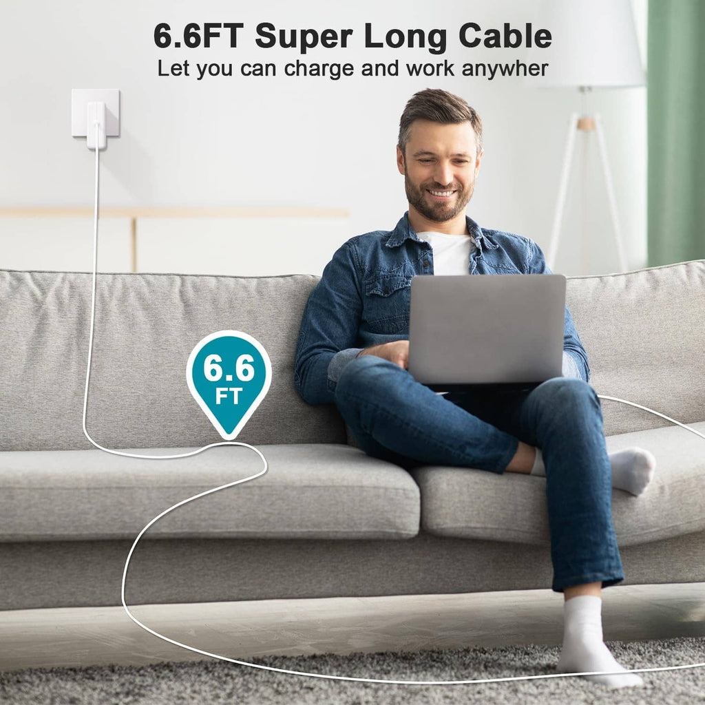 White 6.6 ft 60W charger cable powering a laptop from a sofa
