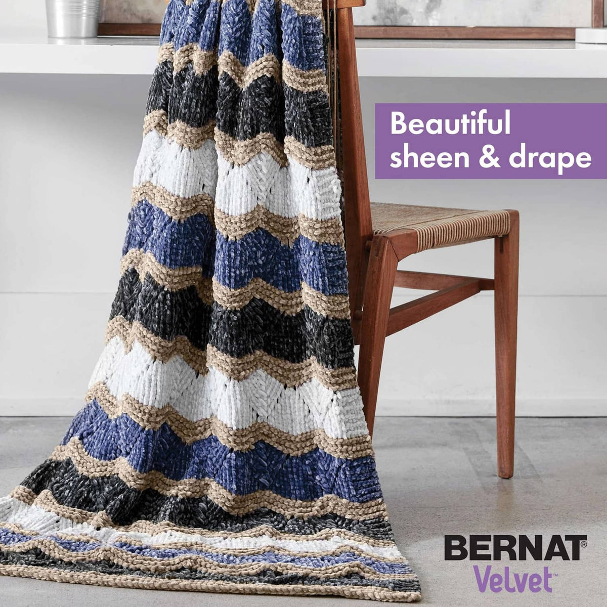 Chunky striped crochet blanket with blue, cream, and dark gray bands