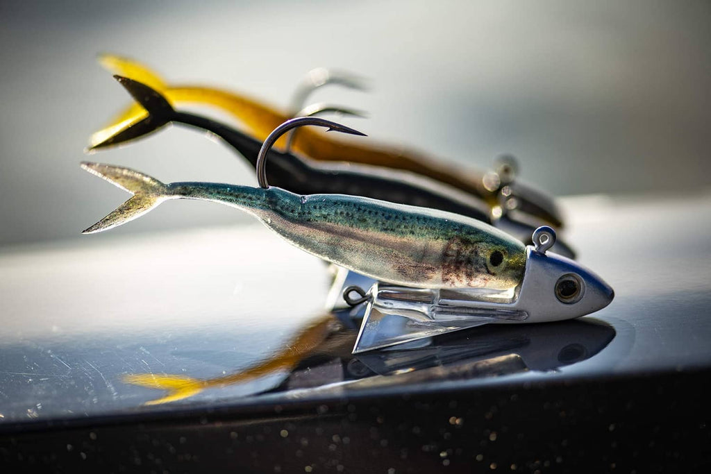 Minnow fishing lure with treble hooks, metallic blue-green body and yellow accents