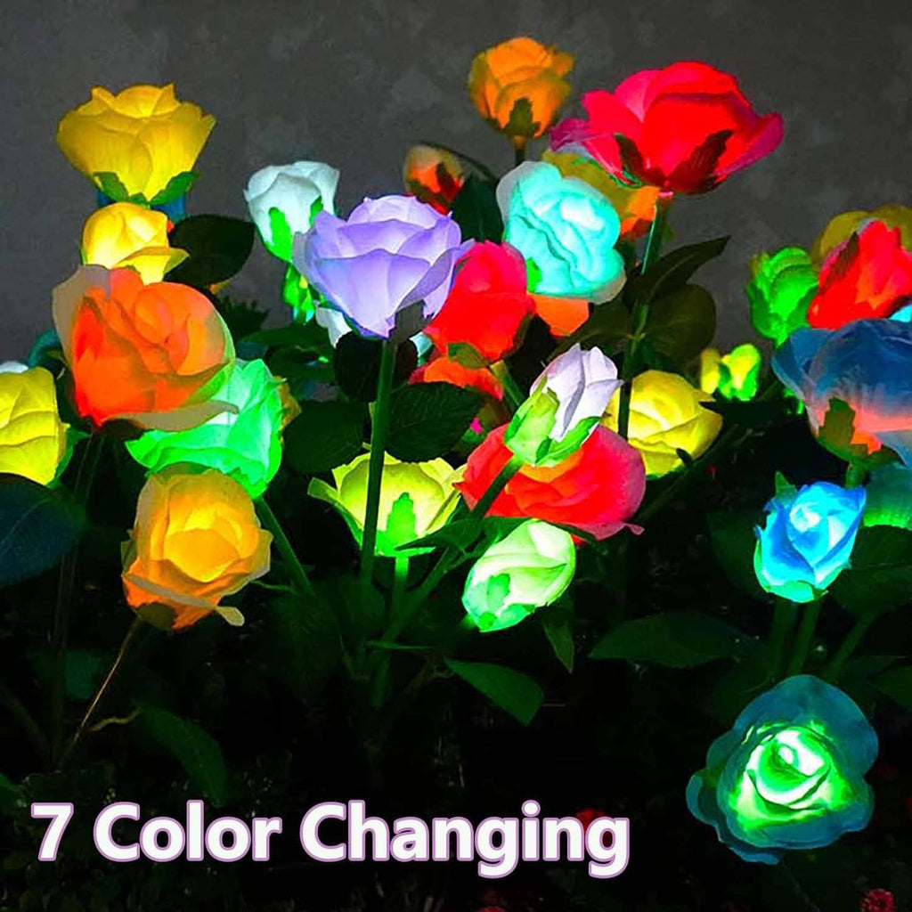 Close-up of color-changing LED rose blooms on green stems with black solar bases
