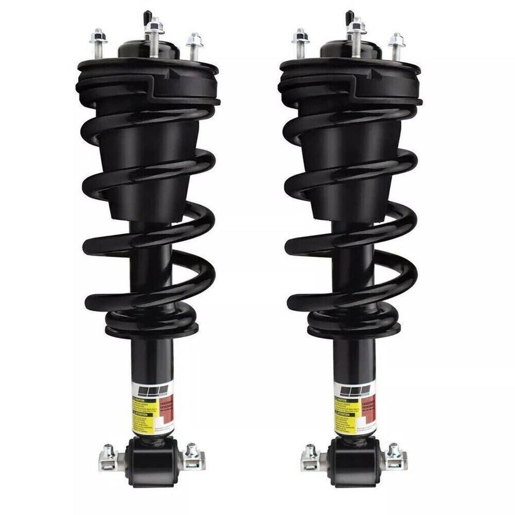 Two front shock struts with black coil springs and top support housings