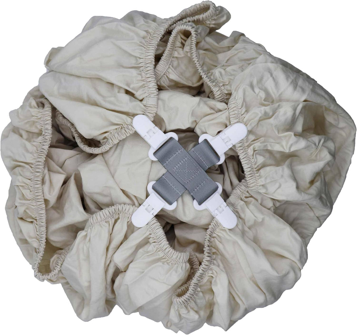 Bed sheet detangler clips attached to light-colored fitted bedding with two gray clamps