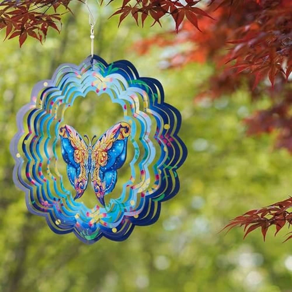 Hanging butterfly wind spinner with blue butterfly center and rainbow-edged layered metal petals