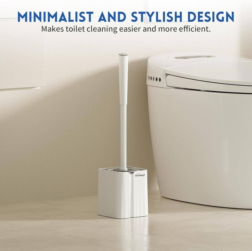 White standing toilet brush and holder set beside a toilet in a bathroom