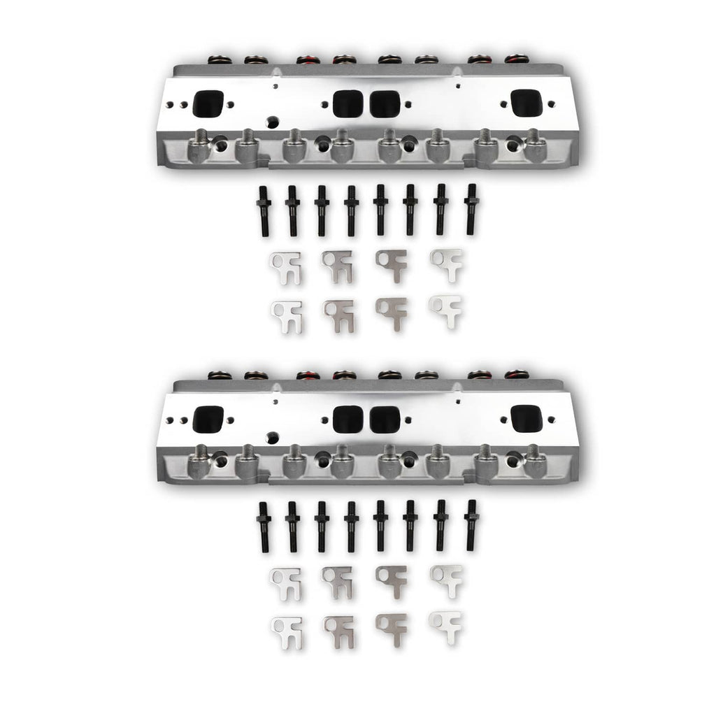 Two aluminum cylinder heads with valve train, plus hardware pieces arranged below