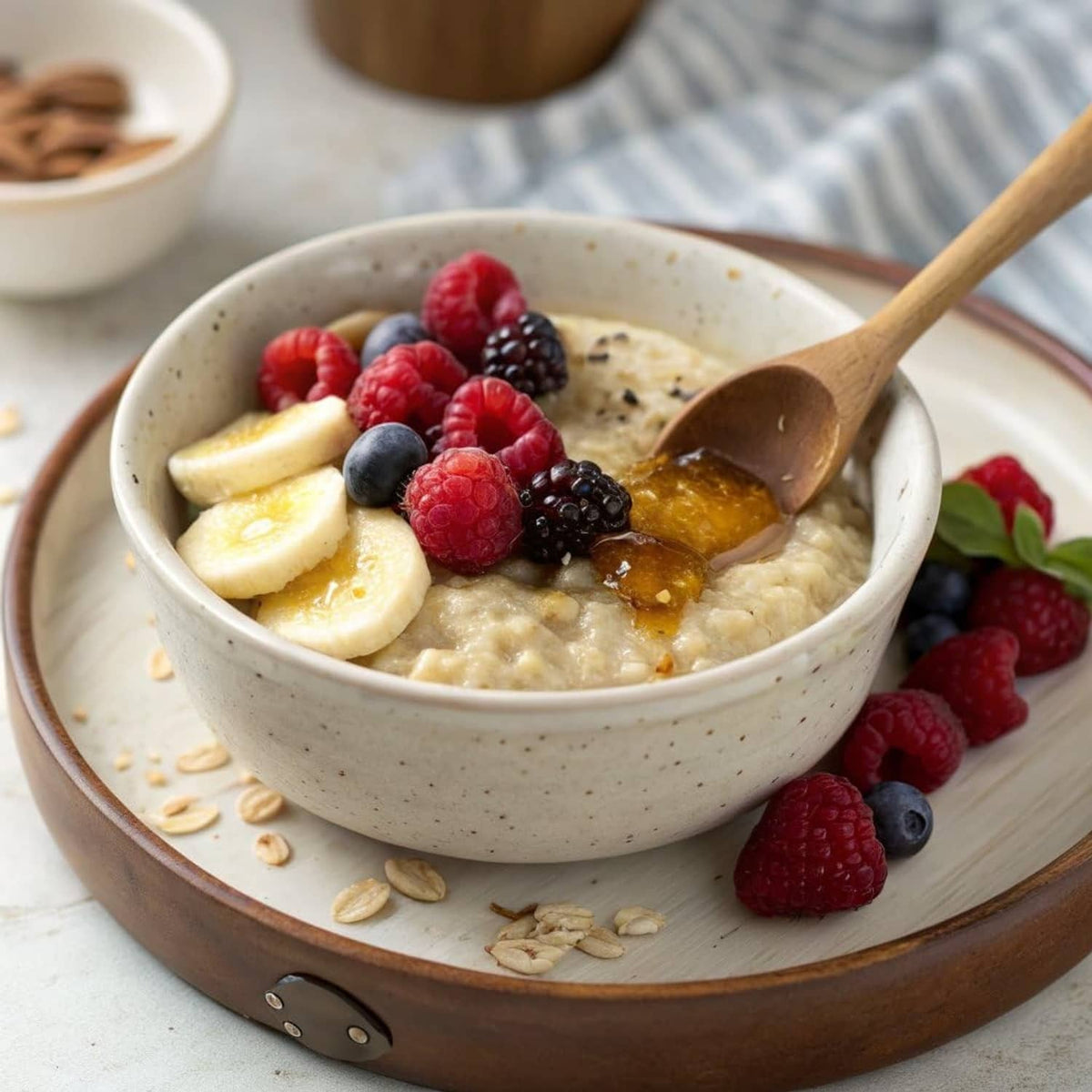 Creamy sprouted oats in a bowl topped with banana slices and mixed berries
